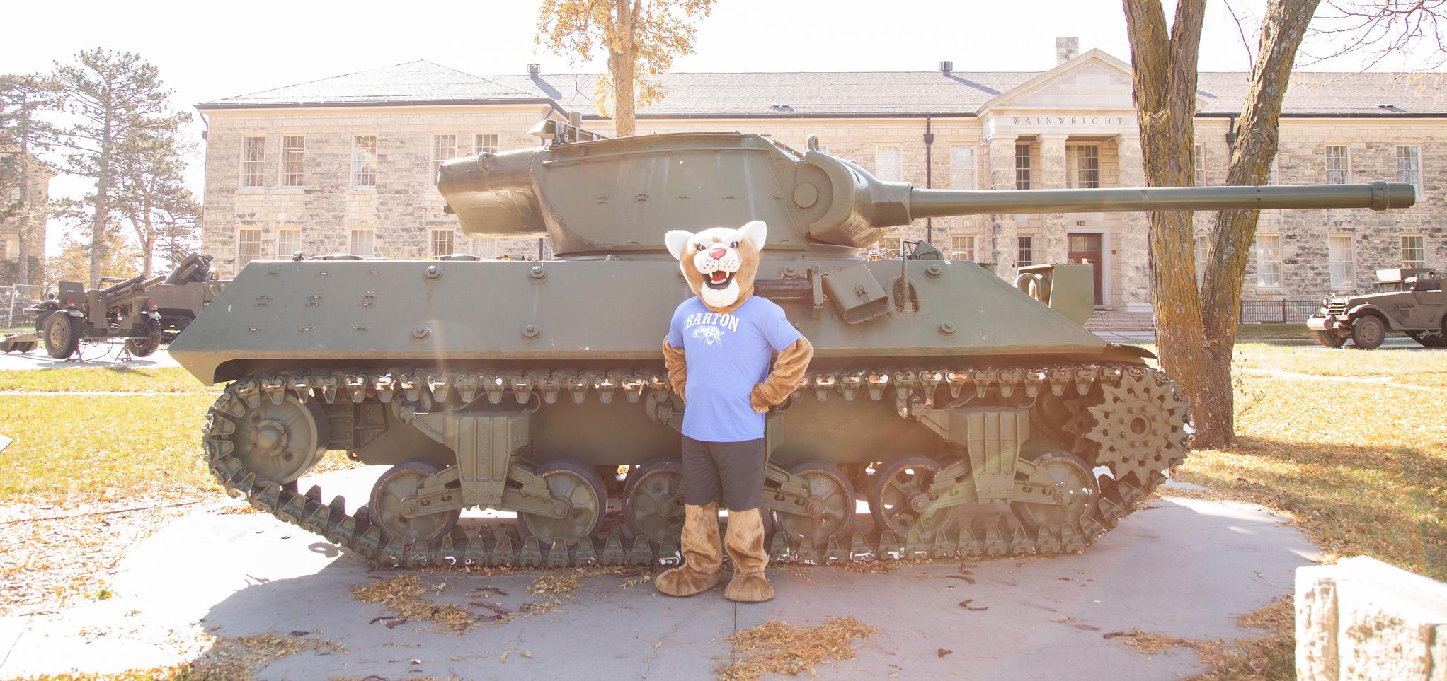 Bart poses by a tank 